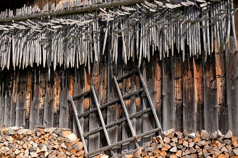 Shed wall with suspended hay riders,
