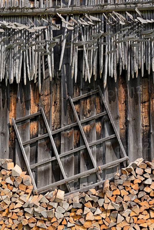 Shed wall with suspended hay riders,