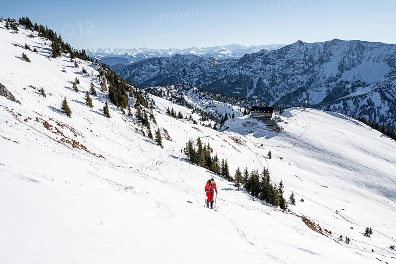 Ski tourers on ski tour on the Rotwand, behind mountain hut Rotwandhaus with mountain panorama