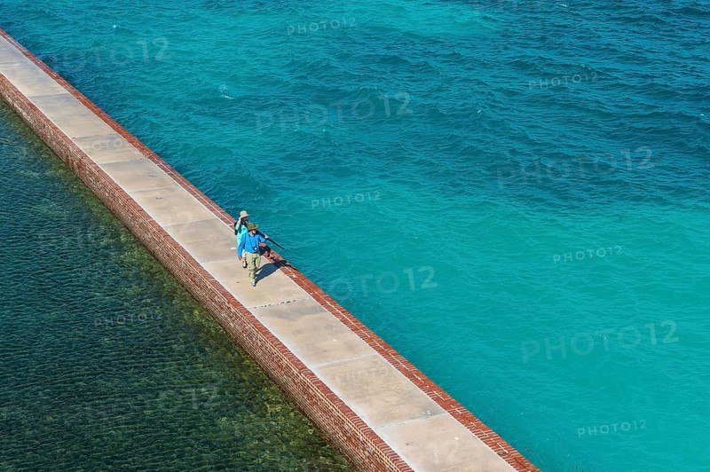 Tourists walking on a Pier surrounding Fort Jefferson, Dry Tortugas National Park