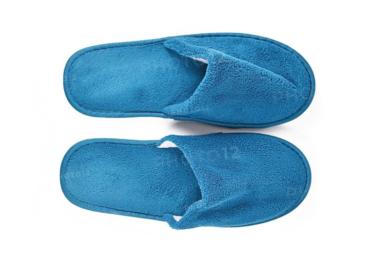 Soft blue home guest slippers on white background,