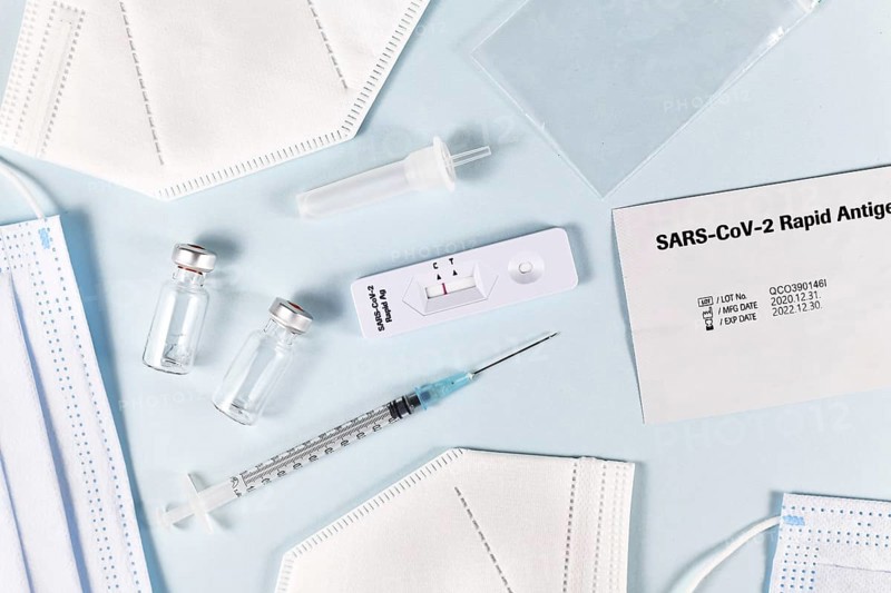 Fight Corona Virus pandemic with tools like rapid antigen test, medical face masks and vaccine vials with syringe