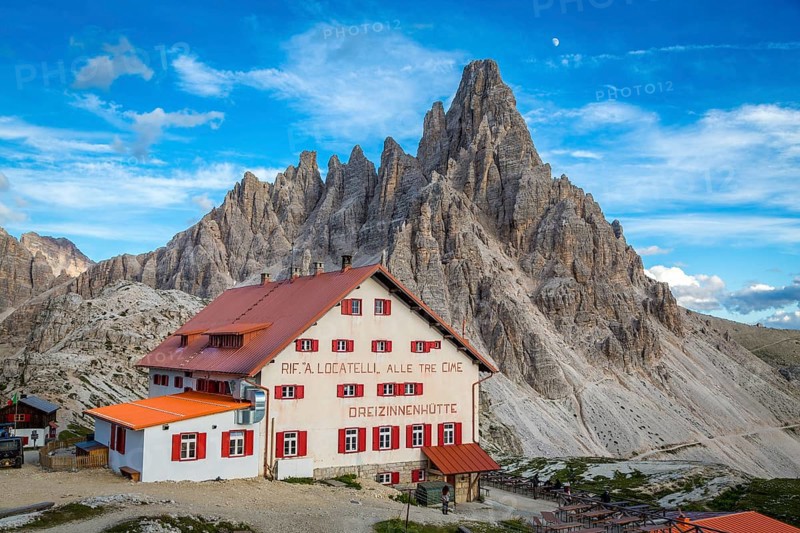 Mountain hut Dreizinnenhuette at dusk, in the background rock massif Paternkofel