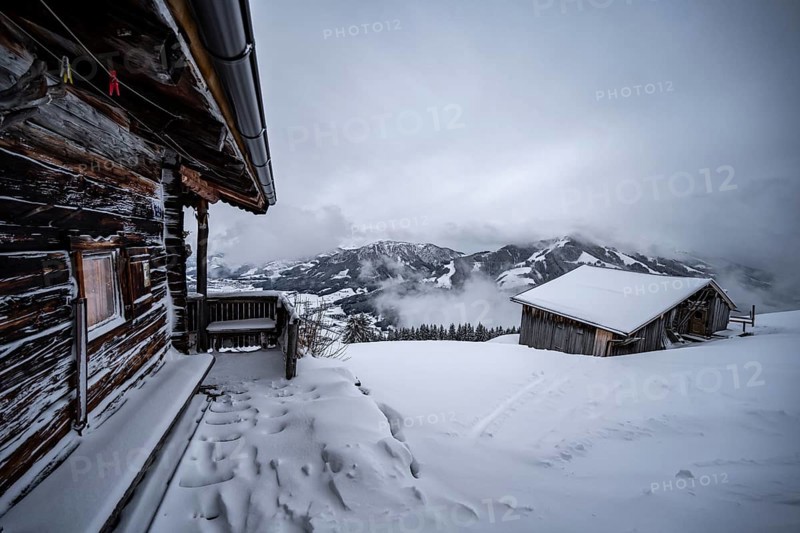 Snowfall, mountain hut in the snow