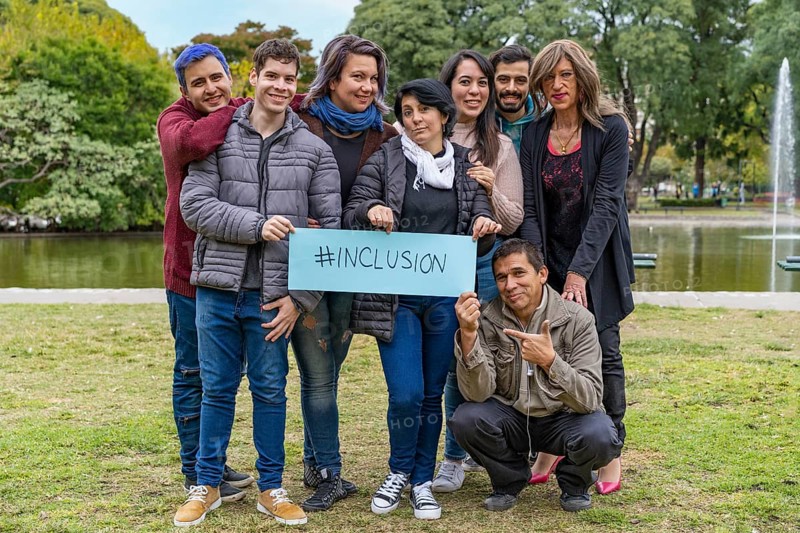 Cheerful queer group holding a message supporting the LGBT community,