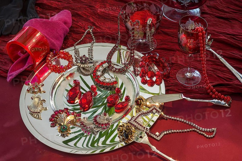 Rhinestone jewellery and accessories decorated on a silver plate and red cloth, Bavaria