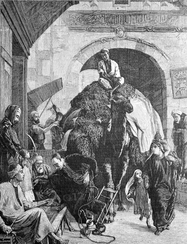 A street in cairo, a merchant with a loaded camel rides through the gate