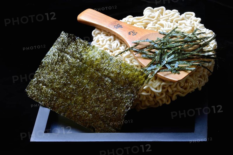 Nori, cut paper-like sheet of seaweed and Asian noodles with chopsticks