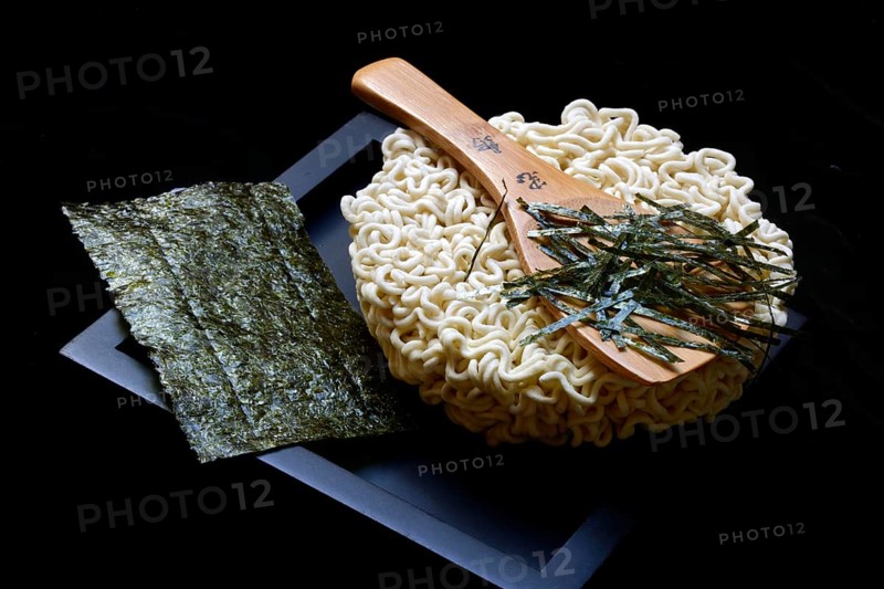 Nori, cut paper-like sheet of seaweed and Asian noodles with chopsticks