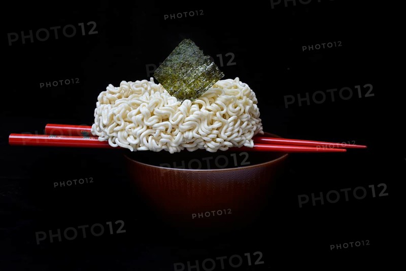 Nori, dried paper-like sheet of seaweed and Asian noodles on a shell