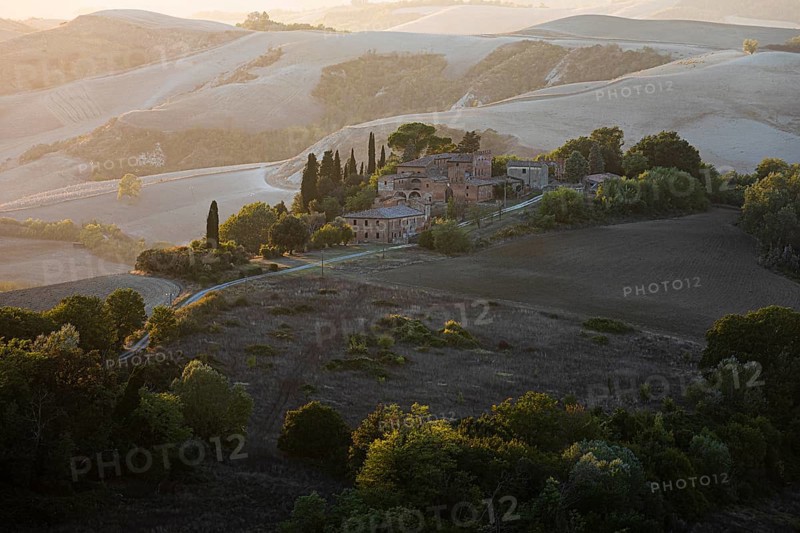 Old country house in the evening light, in hilly landscape of the Crete Senesi