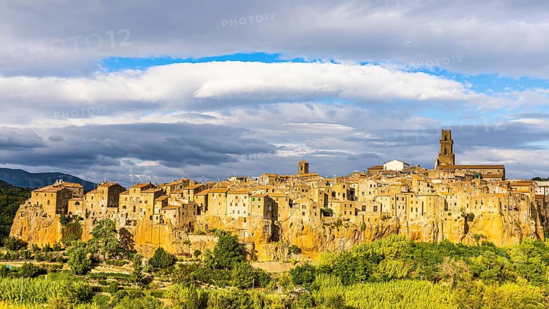 Panoramic view of the medieval town of Pitigliano, dark clouds above