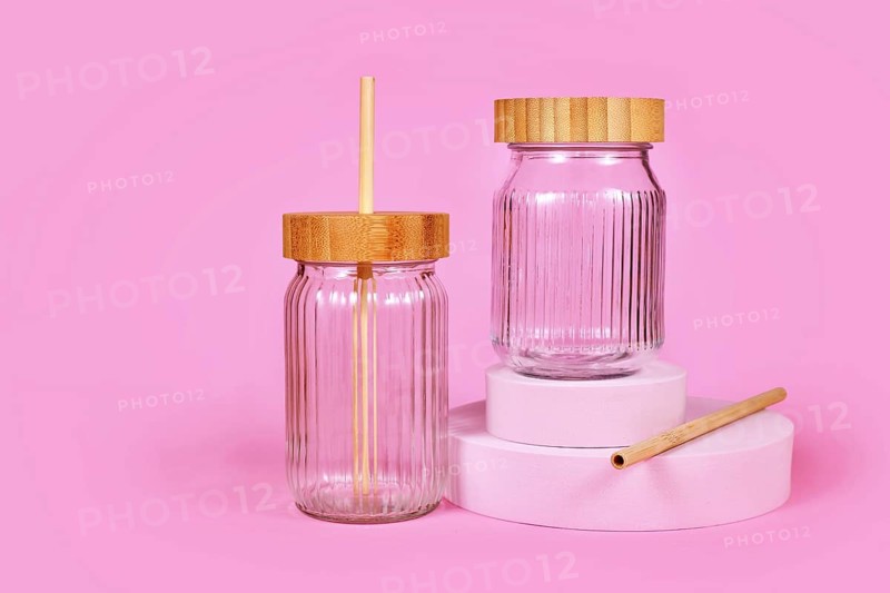 Natural material jars with drinking straws made from glass, wood and bamboo