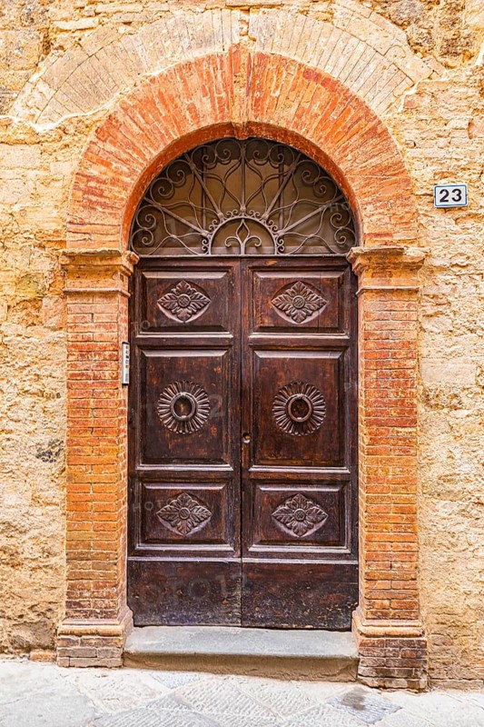 Ornate round arch front door, Montalcino
