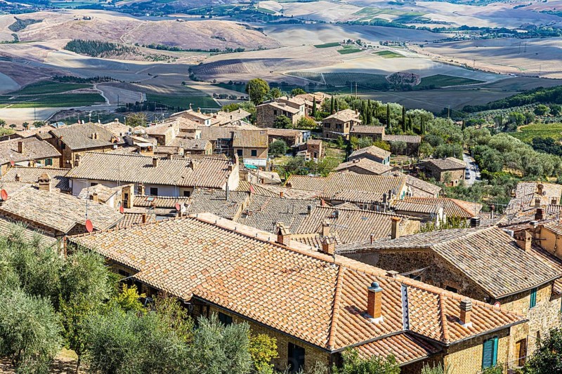 Above the rooftops of Montalcino, view of the Val dOrcia valley