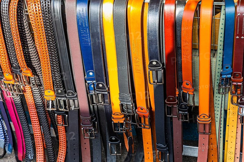 Coloured belts at a stall at the weekly market market in Buonconvento, Val dOrcia