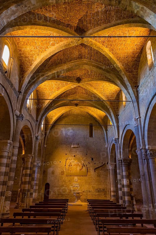The illuminated ceiling vault of Sovana Cathedral, view towards the baptistery