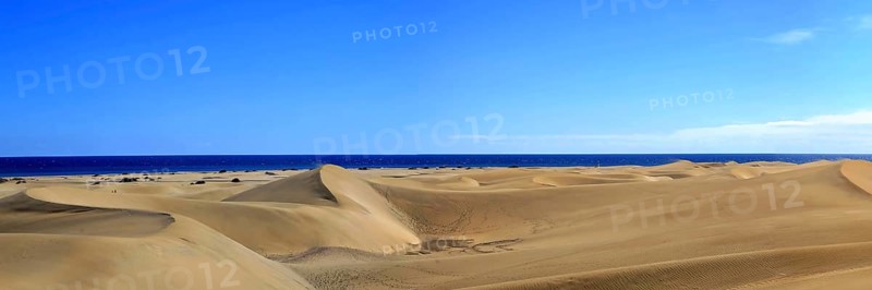 The dunes of Playa Del Ingles with a view of the Atlantic Ocean. San Bartolome de Tirajana, Gran Canaria