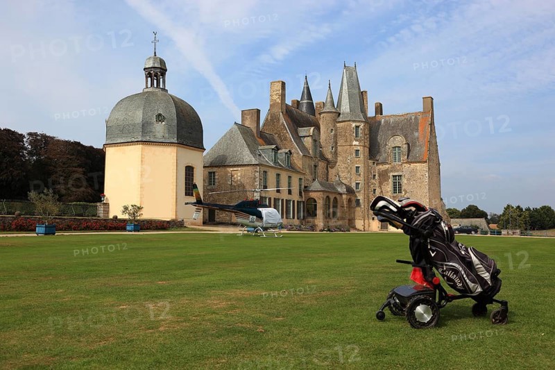Golf trolley in front of the Chateau des Rochers-Sevigne with chapel, near Vitre