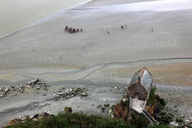View from the monastery hill of Mont Saint-Michel towards the walkers on the mudflats and the Chapelle Saint-Aubert du Mont-Saint-Michel, Basse-Normandie