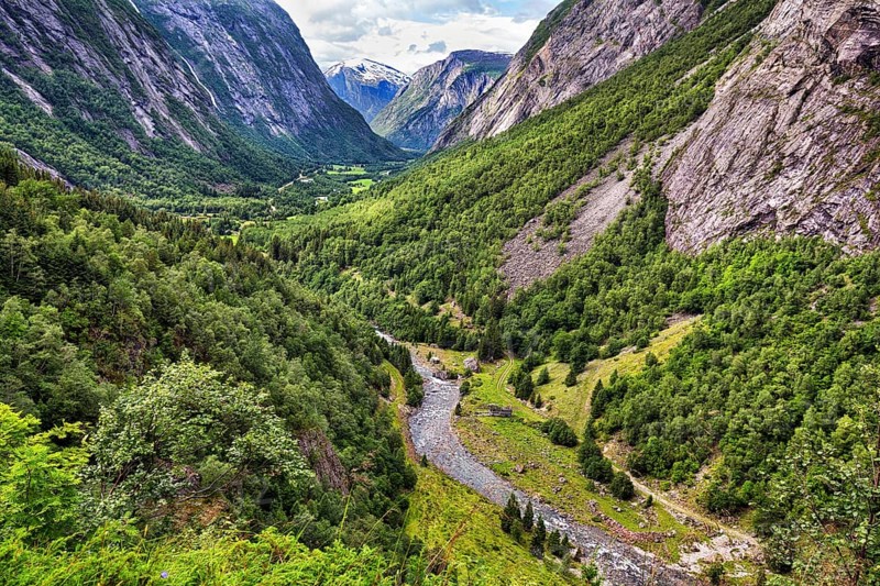 View from above of the forested valley Eikesdalen, high mountains and the river Aura