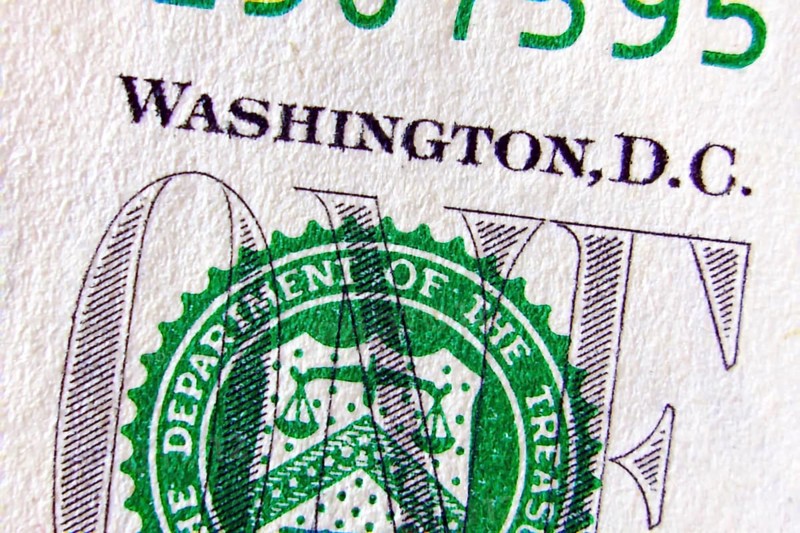 Macro of one dollar note greatly enlarged,