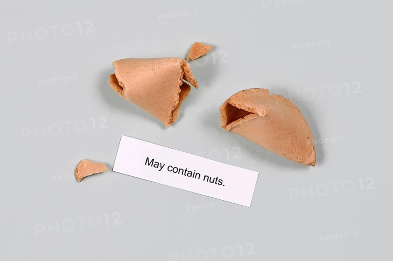 Food allergy concept. Fortune cookie with text 'may contain nuts',