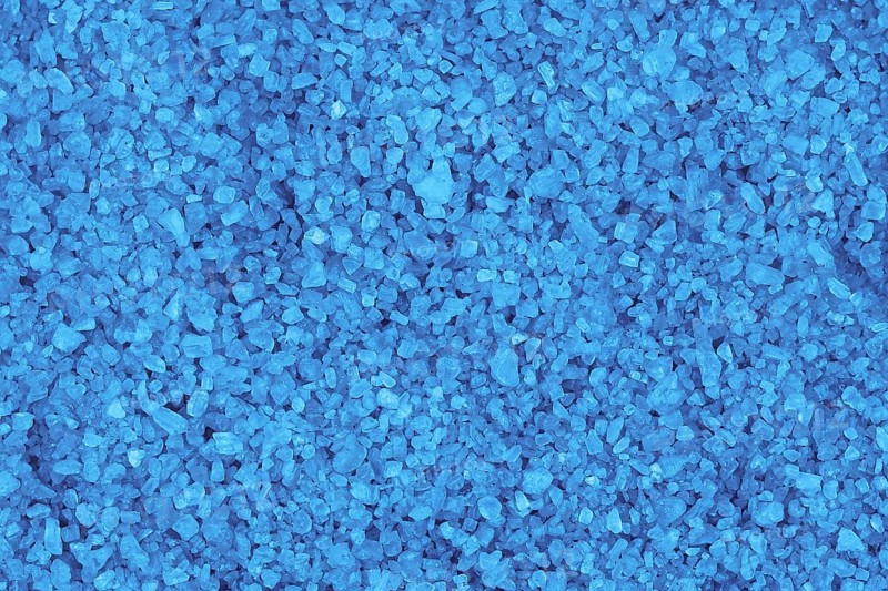 Blue mineral bath salt top view background,