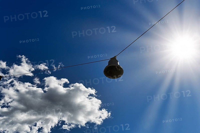Single discarded bell hanging on steel cable, sound body