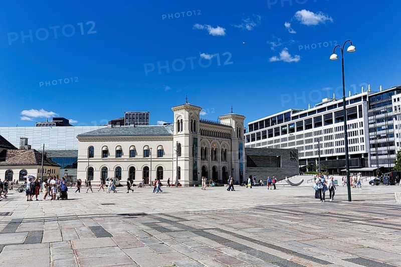 Pedestrians on City Hall Square with Nobel Peace Centre, former West Station