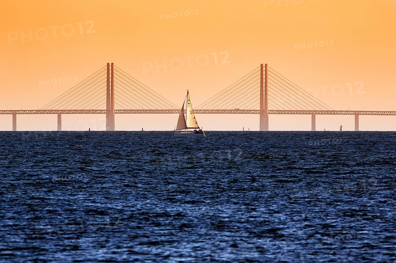 Sailboat in front of the Oeresund Bridge, Oresundsbroen between Malmoe and Copenhagen