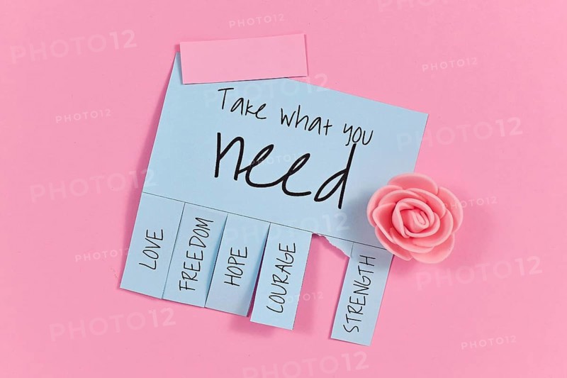 Blue tear-off stub note with text Take what you need and words Love, Freedom