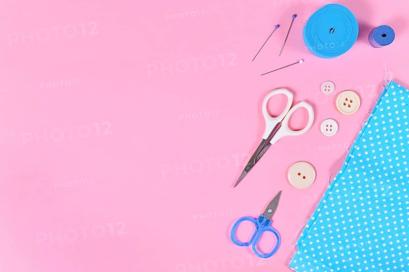 Flat lay with various sewing tools like fabric, scissors