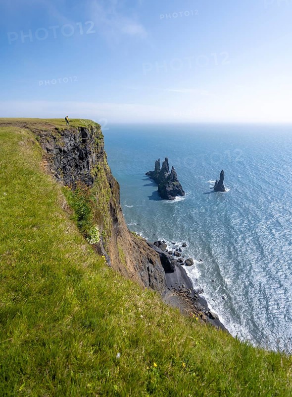 Cliff, rock Reynisdrangar in the water