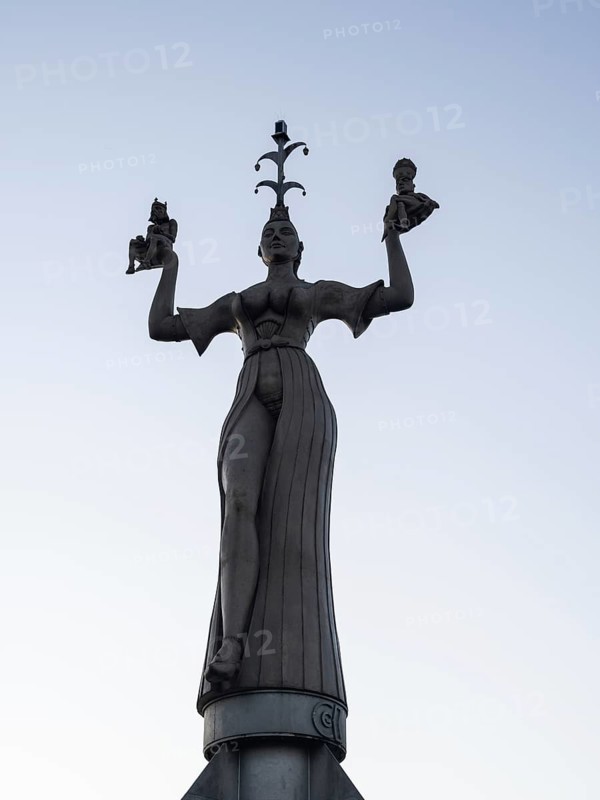 Statue of Imperia at the harbour entrance of Constance in the morning light in front of sunrise, Old Town