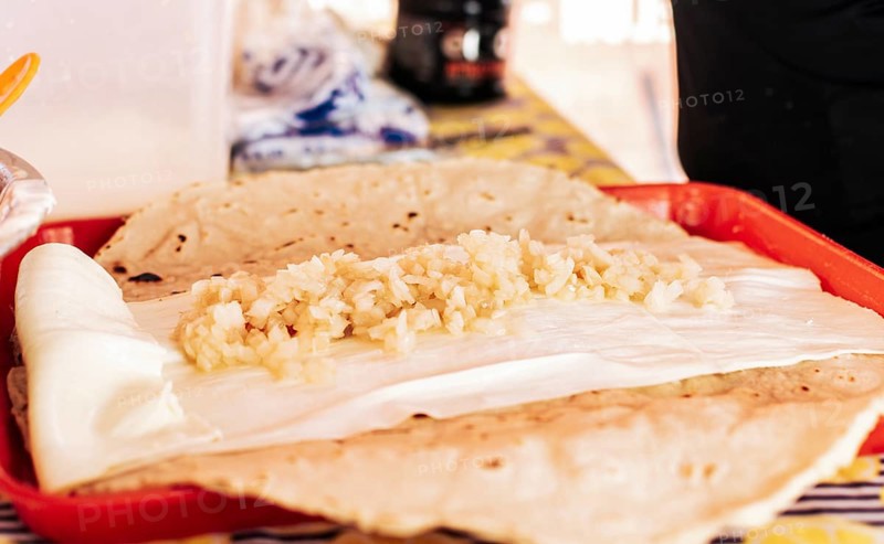 Traditional Quesillo with pickled onion, Preparation of Traditional Nicaraguan Quesillo. Person making delicious Nicaraguan cheese. Hands preparing the traditional Nicaraguan Quesillo