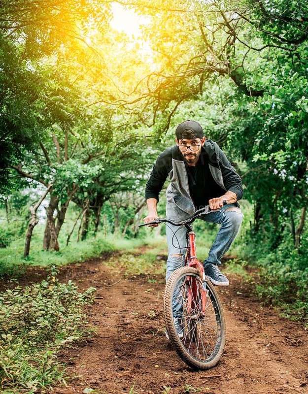 A guy riding a bike in the countryside, Person riding a bike in the countryside