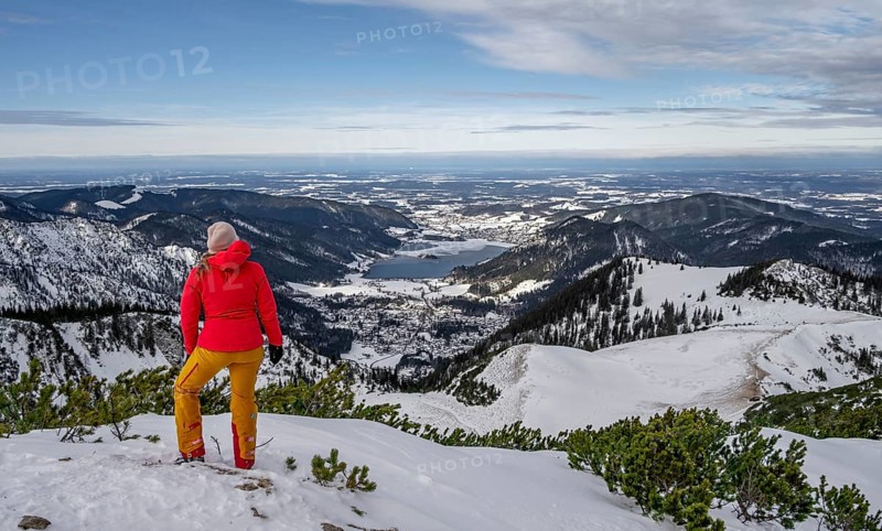 View of Schliersee, ski tourer at the summit of Jaegerkamp in winter