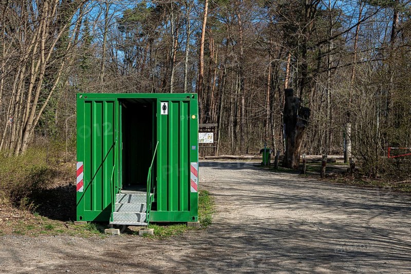 Green toilet container in Tegeler Forst, Berlin