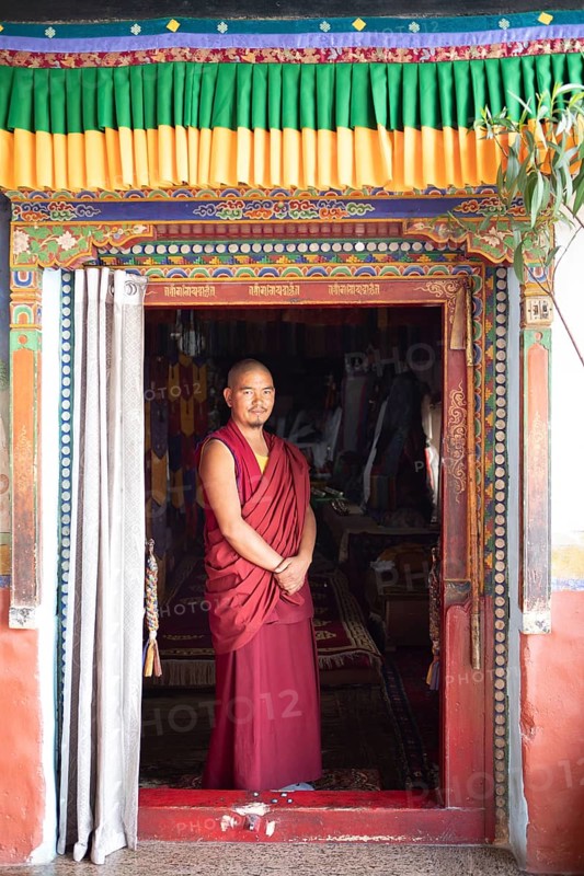 Monk at the entrance to the prayer hall, Diskit Monastery or Deskit Gompa