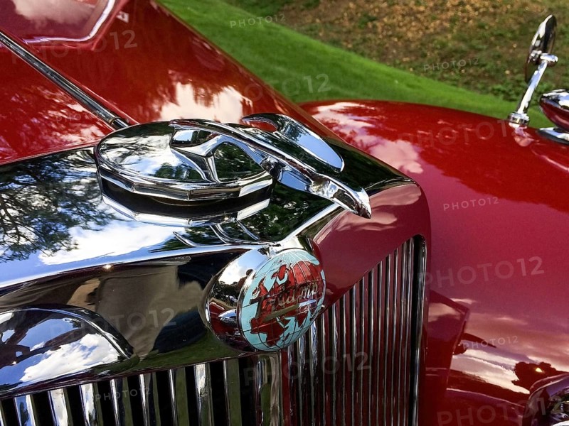Radiator mascot and classic logo with world map and lettering Triumph of historic classic sports car Triumph 1800 Roadster, Classic Days
