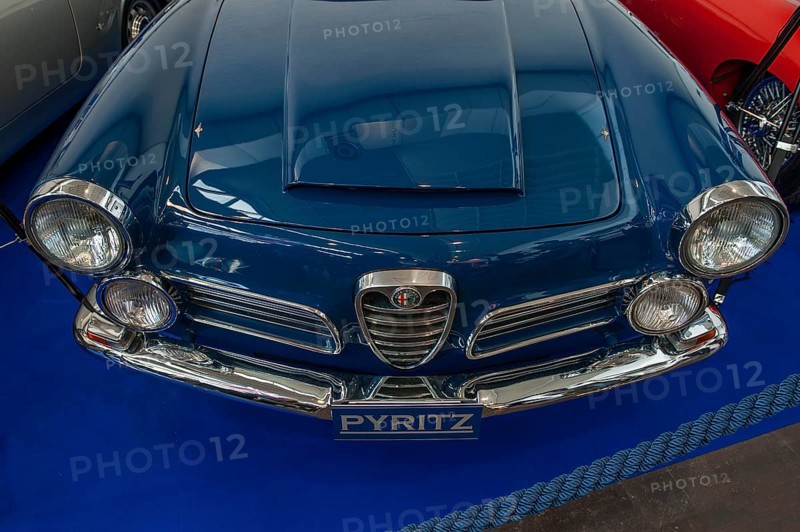 Front of classic Alfa Romeo 2600 Spider with radiator grill Scudetto and air scoop hat on the bonnet, two pairs of round headlights