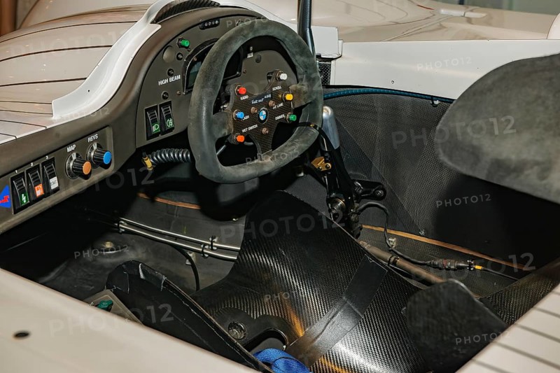 View into cockpit of historic racing car BMW V12 LMR Le Mans for 24h 24 hours race in 90s 1999 with dashboard modern steering wheel racing steering wheel, Messe Techno Classica