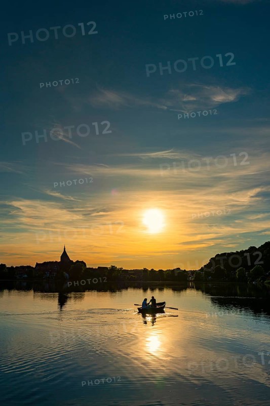 Rowing boat at sunset on the Ziegelsee, Moelln