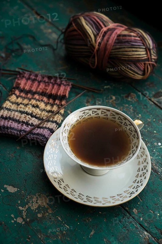 Handmade, Knitted piece with knitting needles and coffee