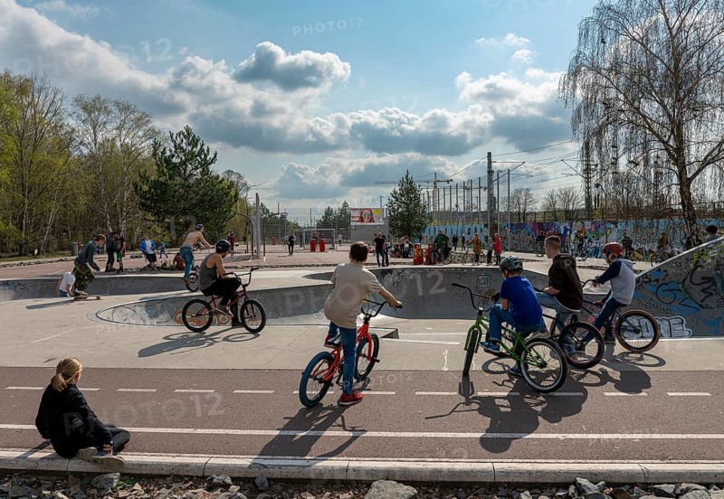 Skateboarders and cyclists at a skate pool in the Park am Gleisdreieck in Berlin-Mitte, Berlin