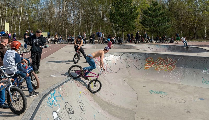 Skateboarders and cyclists at a skate pool in the Park am Gleisdreieck in Berlin-Mitte, Berlin