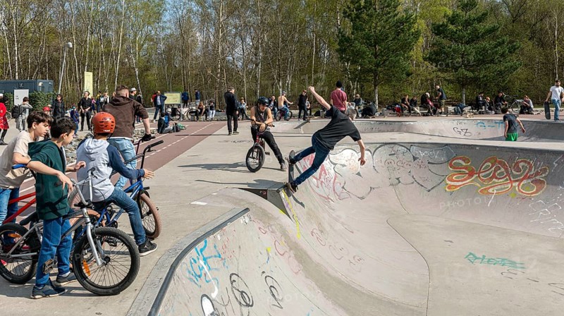 Skateboarders and cyclists at a skate pool in the Park am Gleisdreieck in Berlin-Mitte, Berlin