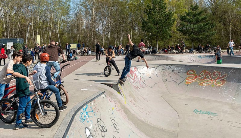 Skateboarders and cyclists at a skate pool in the Park am Gleisdreieck in Berlin-Mitte, Berlin