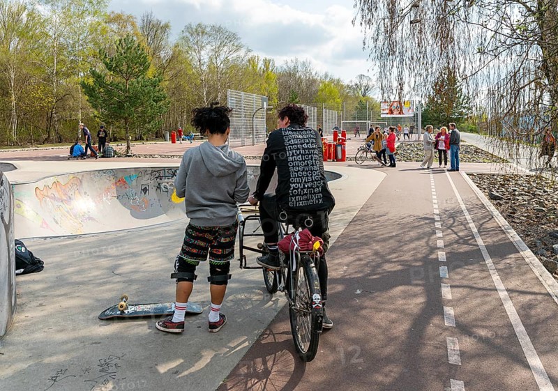 Skateboarders and cyclists at a skate pool in the Park am Gleisdreieck in Berlin-Mitte, Berlin